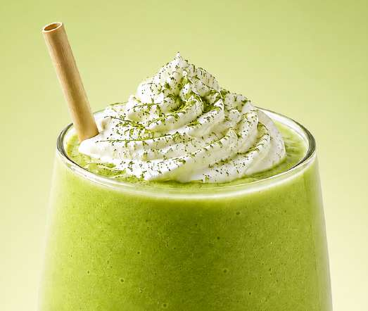 Matcha smoothie topped with cream